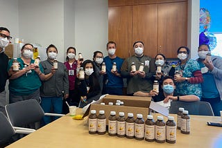 frontline healthcare workers hold juices from urban remedy