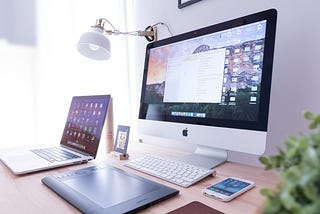 macbook, laptop, and iphone desk setup