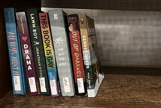 Photo of a shelf of banned books with a halftone overlay