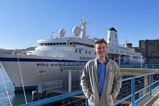 Foster stands in front of the MV World Odyssey.