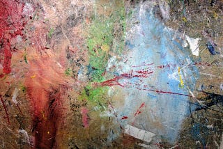 A splatter of paint in browns, reds, and some other colors.