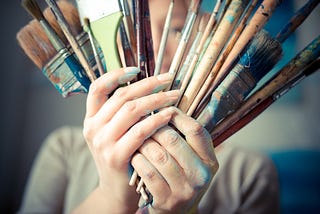 Painter with used paintbrushes