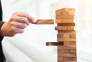 A person fixing a wooden puzzle