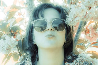woman in sunglasses in the blossom tree taken using vintage lens-COPYRIGHT SARAH-JANE WHITE 2020