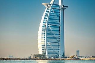 Photo of Burj Al Arab in Dubai whose shape ironically resembles the sail of a boat. Photo by Darcey Beau on Unsplash.