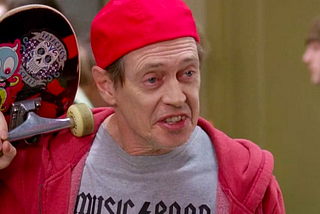 Steve Buscemi dressed as a skater boy, complete with “Music Band” T-shirt.