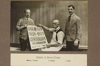 Black and white image featuring three men, one seated holding the Manchester Guardian centenary paper, 1821–1921. Features the names of gneeral printers Lomas, Speight and Dale.