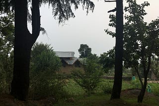 A mud house in Bir, Himachal Pradesh surrounded by fields