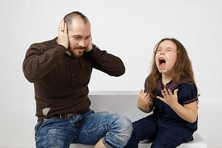 A young girl with an upset expression, standing with crossed arms as her father looks on with a concerned and apologetic face. The scene captures the emotional tension of a strained father-daughter relationship