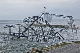Roller coaster structure partly submerged in high ocean water