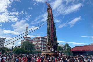 Devotees worshiping the red chariot of Matsyendranath being taken to Jawalakhel in Lalitpur.