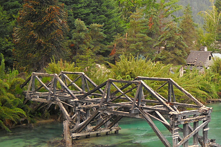 Ruined bridge above glacial waters in Bariloche, Argentina