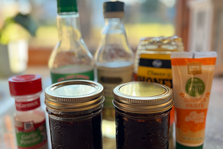 Two servings of stir fry sauce in front of the ingredient used to make it