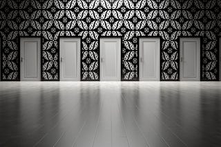 Five doors along a black and white patterned wall