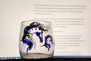 Horse wineglass with writing in the background