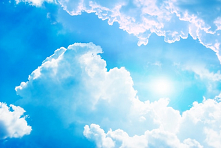Image of sun shining in a blue sky with a few white clouds to illustrate post