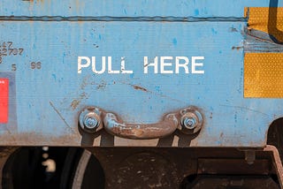 “Pull here” written above a handle