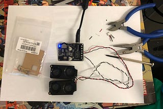 Workstation with old laptop speakers, amplifier board and tools