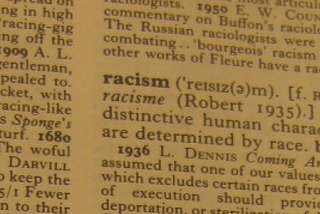 A photo of the word “racism” in a dictionary