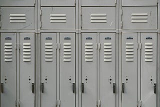 Image shows a close up view of eight stereotypical school lockers