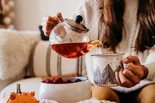 Closeup of hands pouring a soothing cup of tea.