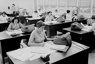 Macie Roberts’ (far right) computing group, circa 1955. Barbara Paulson (back left) stands on the telephone. Helen Ling works on calculations (second desk in the left row).