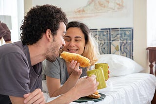 Couple having breakfast in bed.