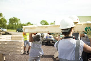 An image of people building a zero-carbon house using the WikiHouse system