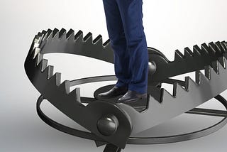 Open jawed bear trap with a man standing in the middle