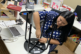 Ashley Alvarado assembling a stool in her office.