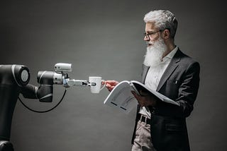 Robotic arm giving a cup to a human illustrating the already written source code of data science tools and the coders’ lack of understandability with preimplemented machine learning methods