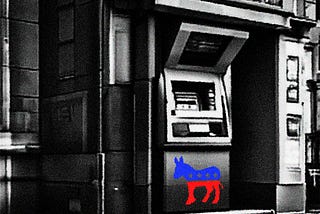 An ATM on a street corner with the Democratic Party logo of a blue and red stylized donkey with stars on its body. The image is in grainy, stark black and white except for the donkey.