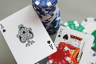 blackjack cards next to stacked casino chips