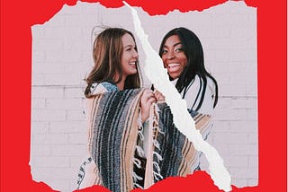 A white woman and black woman laughing, sharing blanket, photo torn