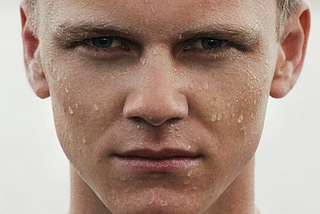 white man with beads of water or sweat on face