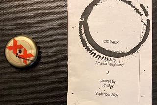 front cover of a zine called Six Pack with a bottle cap attached to the sewn binding