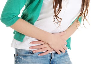 Girl with stomach ache from eating dietary fiber.