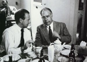 An image of Heisenberg and Bohr sitting and having tea