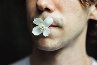 Man with a flower in his mouth