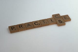 Scrabble tiles form the word practice