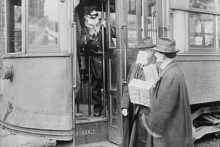 Streetcar riders required to wear masks during flu epidemic in Seattle, 1918.