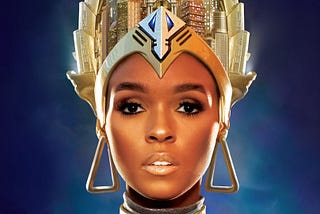 Janelle Monáe’s face from the cover of her album Archandroid. She is wearing a crown or headdress resembling skyscrapers.