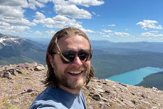 A photograph of Seth. The background is a mountain landscape with a river running through.