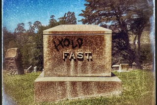 Vintage photo of a gravestone that says, “Fast.” Someone spray-painted the word, “Hold” above “Fast”.