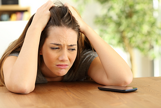Girl waiting for a text or phone call from a date who ghosted her.
