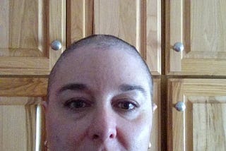 This is a picture of me after my second chemotherapy treatment. I have stubs of hair.