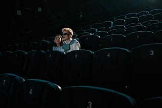 Couple sitting in theater.