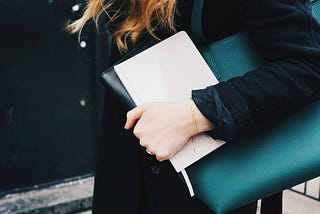 Women holding bag and notebook