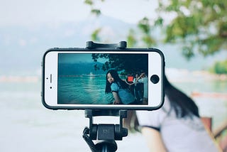 photo from behind a phone livestreaming a trip to the beach