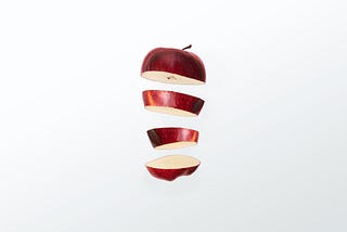 A red apple sliced up.
